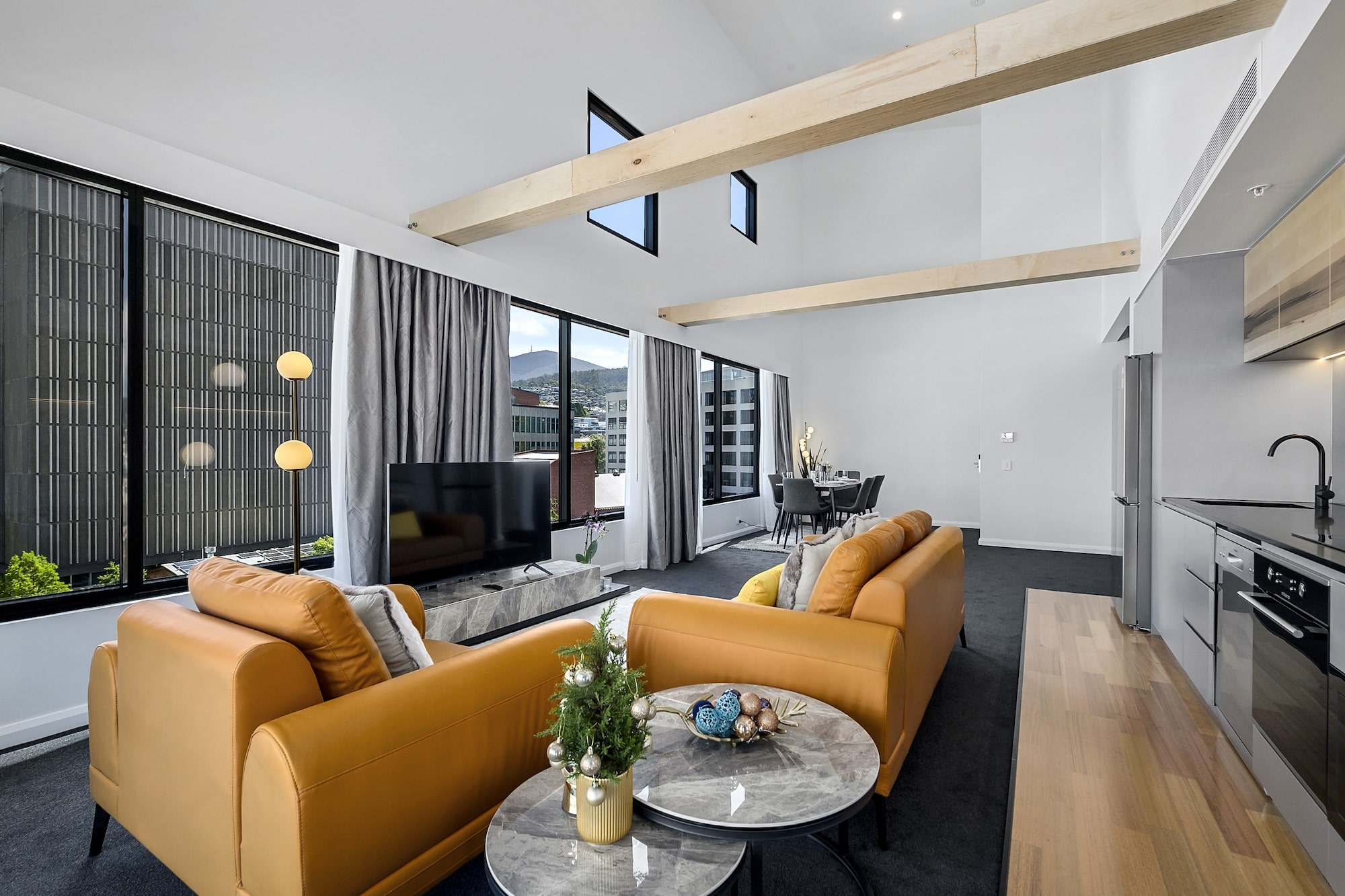 Penthouse living area at Hobart City Apartments with a view of Mount Wellington
